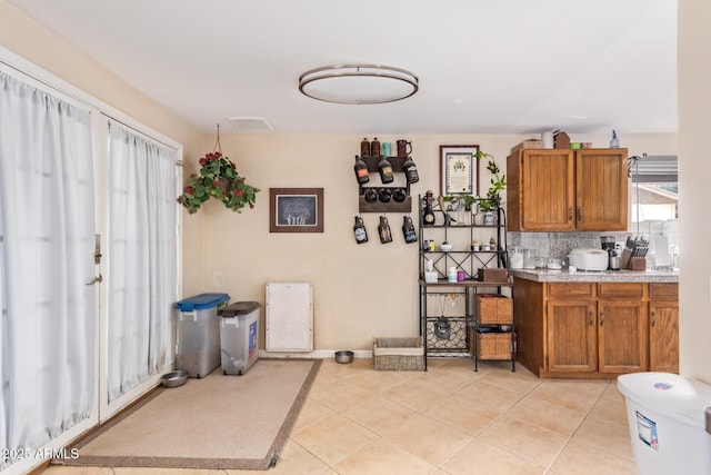 kitchen with decorative backsplash and light tile patterned floors