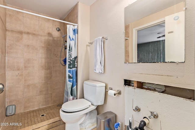 bathroom with a shower with curtain and toilet