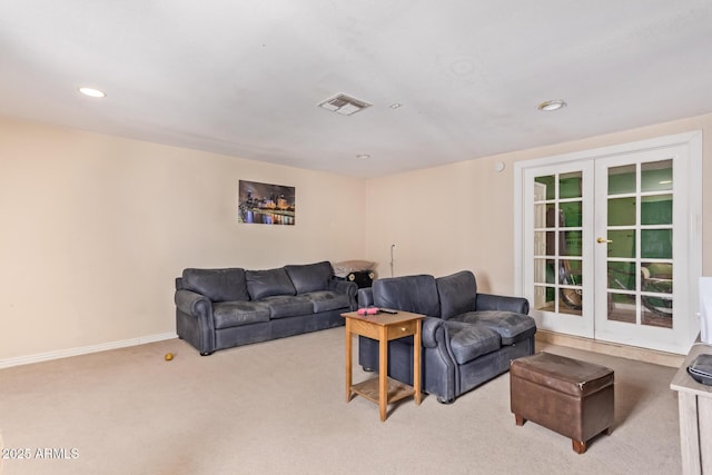 carpeted living room featuring french doors