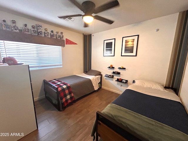 bedroom with ceiling fan and dark wood-type flooring