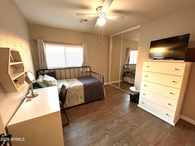 bedroom featuring ceiling fan, dark hardwood / wood-style flooring, and a closet