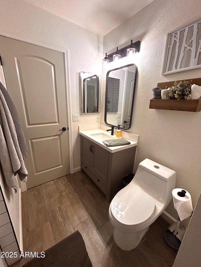 bathroom with toilet and vanity