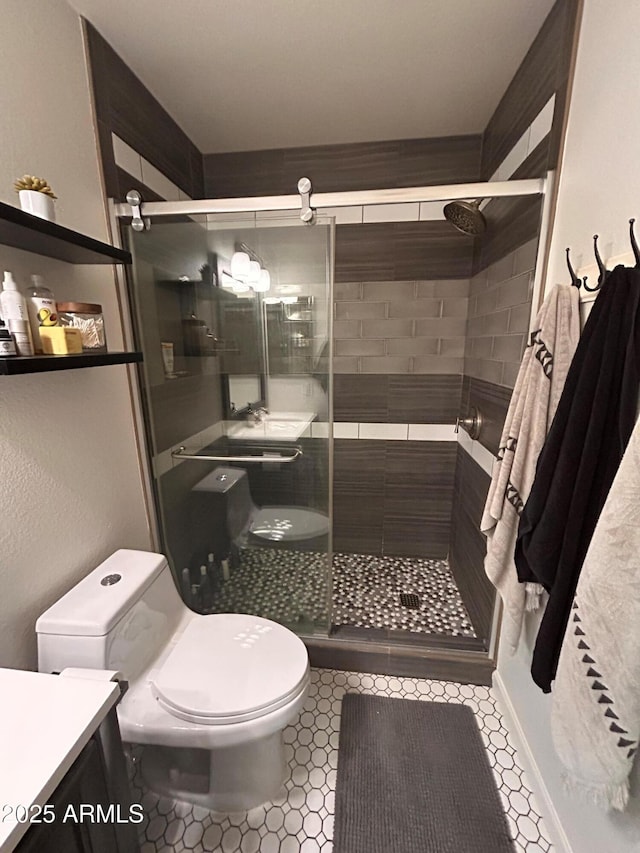 bathroom with toilet, an enclosed shower, tile patterned floors, and vanity