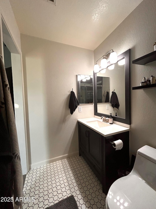 bathroom featuring vanity and toilet