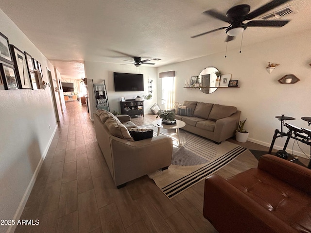 living room featuring a textured ceiling and dark hardwood / wood-style floors