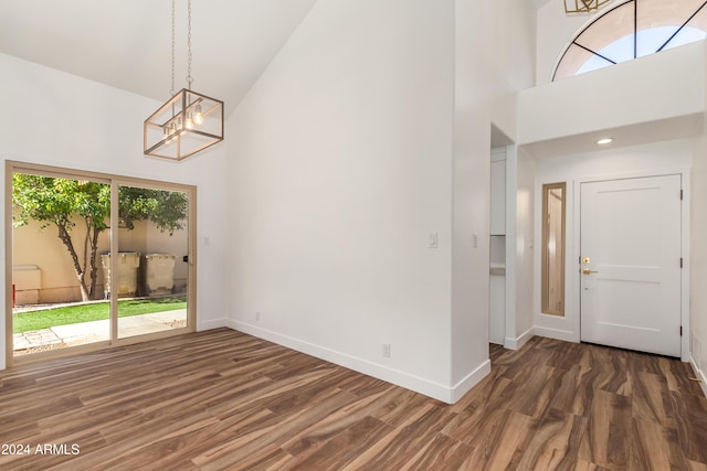 foyer featuring dark hardwood / wood-style floors, a chandelier, and high vaulted ceiling