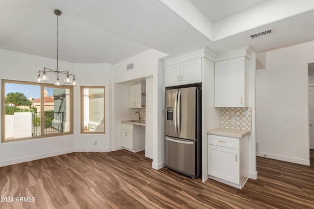 kitchen with stainless steel refrigerator with ice dispenser, white cabinetry, dark wood-type flooring, and backsplash