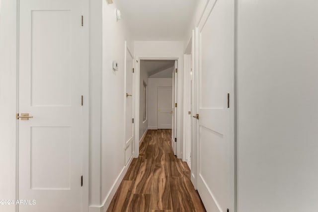 corridor featuring dark hardwood / wood-style flooring