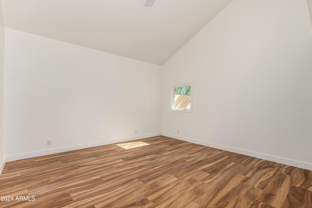 unfurnished room featuring hardwood / wood-style floors and high vaulted ceiling