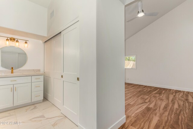 bathroom featuring vanity, vaulted ceiling, and ceiling fan