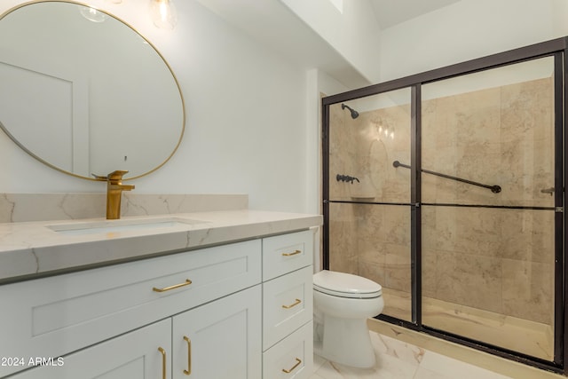 bathroom featuring vanity, a shower with shower door, and toilet