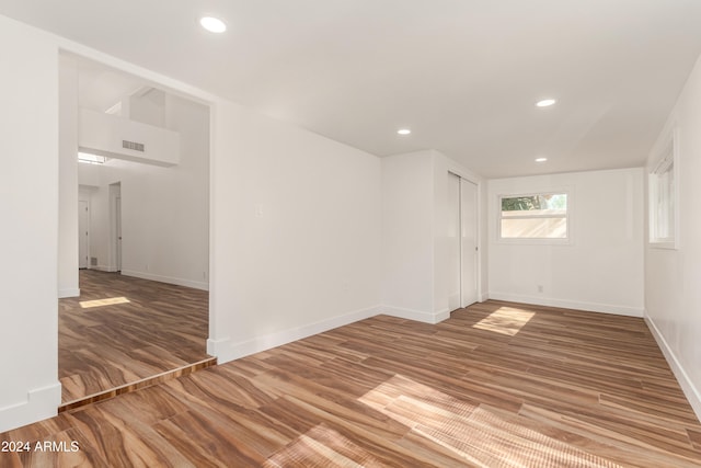 empty room with hardwood / wood-style flooring