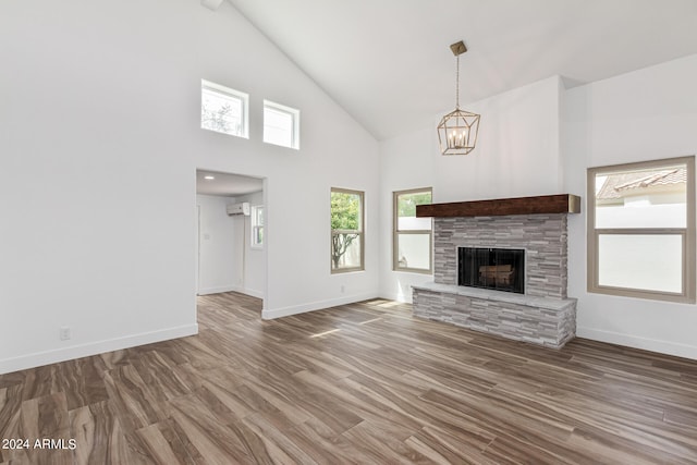 unfurnished living room with beamed ceiling, wood-type flooring, a fireplace, and high vaulted ceiling