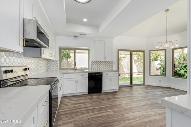 kitchen featuring white cabinetry, appliances with stainless steel finishes, and a healthy amount of sunlight