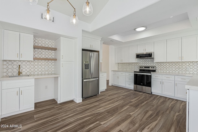 kitchen featuring white cabinetry, appliances with stainless steel finishes, sink, and pendant lighting