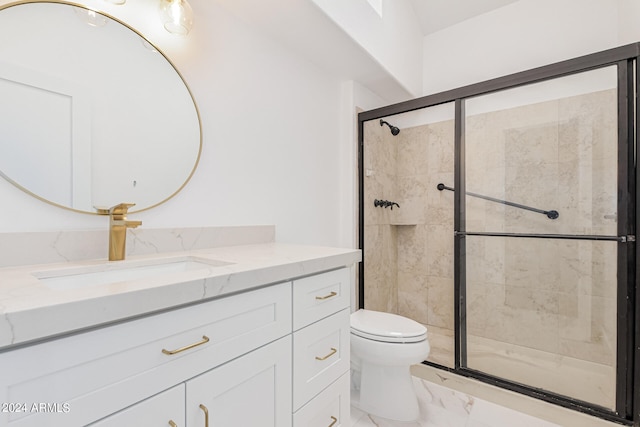 bathroom with vanity, an enclosed shower, and toilet