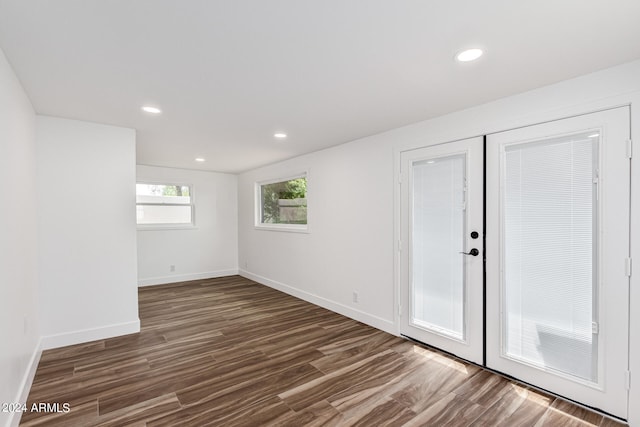 empty room featuring dark hardwood / wood-style flooring and french doors