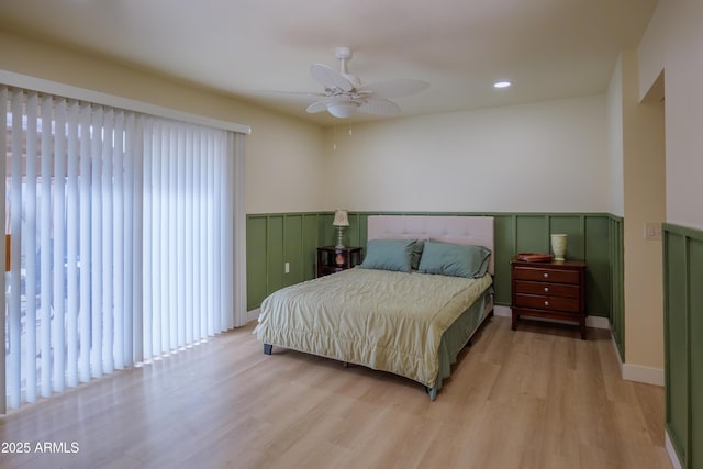 bedroom with ceiling fan and light hardwood / wood-style flooring