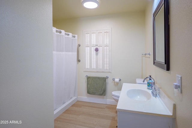 bathroom featuring vanity, hardwood / wood-style floors, toilet, and walk in shower