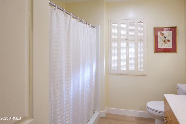 bathroom with vanity, a shower with shower curtain, and toilet