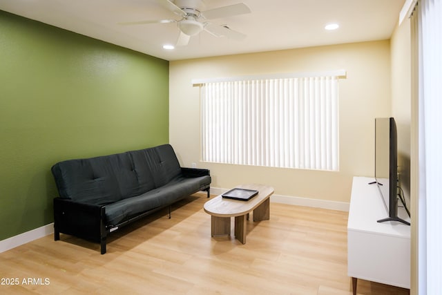 sitting room featuring ceiling fan and light hardwood / wood-style floors