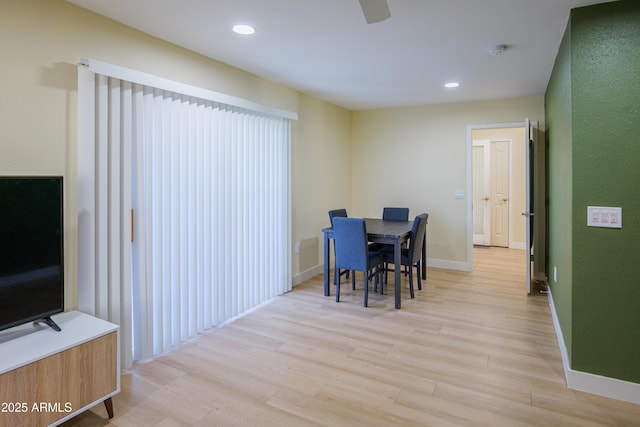 dining room with ceiling fan and light wood-type flooring