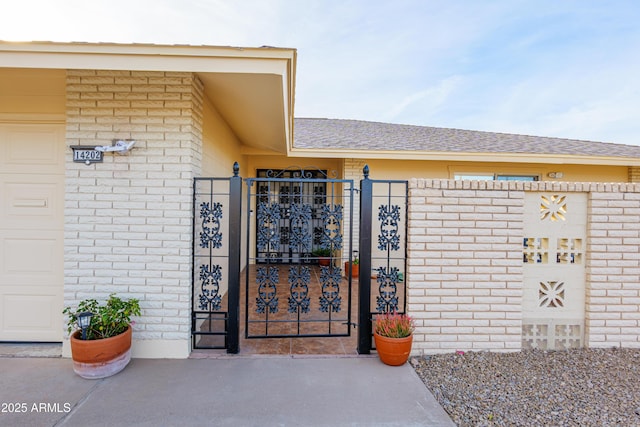 view of gate with a garage