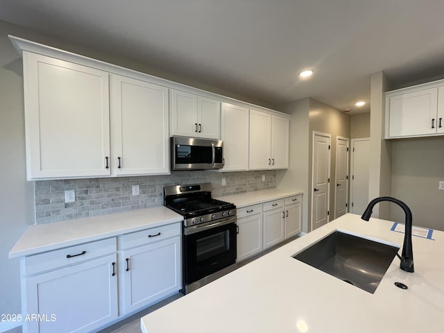 kitchen with stainless steel appliances and white cabinets