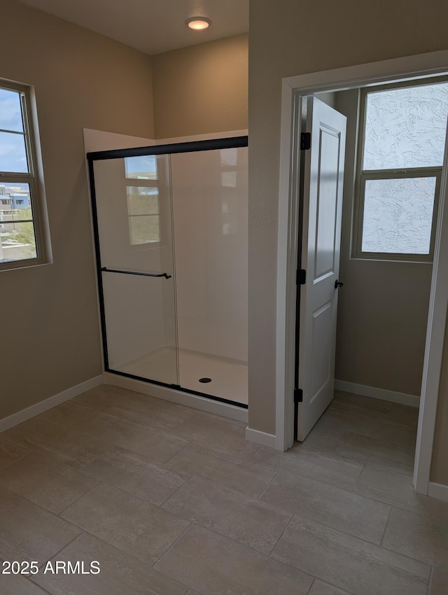 bathroom featuring a shower with door and tile patterned floors