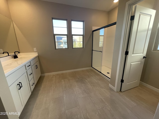 bathroom featuring hardwood / wood-style flooring, vanity, and walk in shower