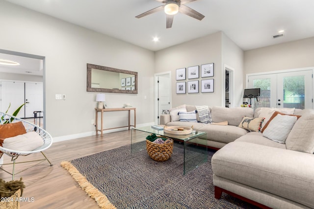 living room featuring french doors, ceiling fan, and wood-type flooring