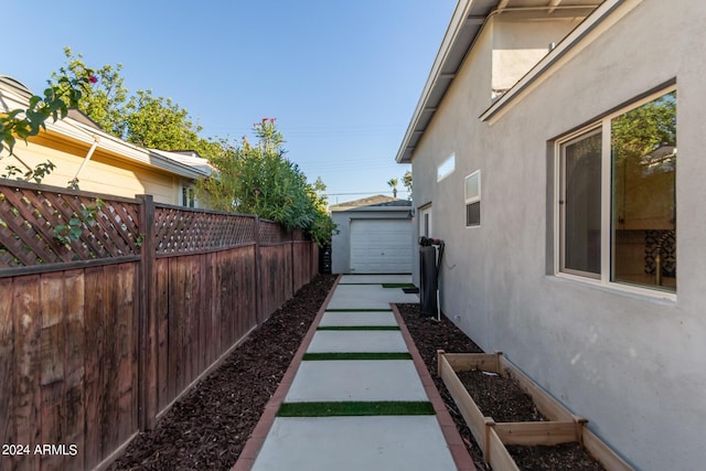 view of yard with a garage and an outbuilding