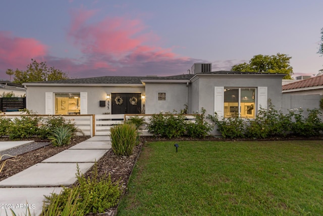 contemporary home with a yard and cooling unit