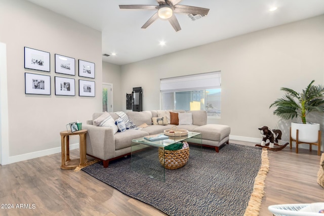 living room with a healthy amount of sunlight, wood-type flooring, and ceiling fan