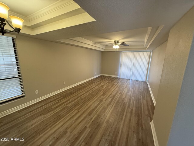 3434 W Danbury Dr Unit A206, Phoenix, AZ 85053 - spare room featuring a tray ceiling, dark wood-style flooring, ceiling fan, a chandelier, and ornamental molding