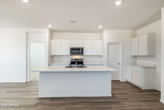 kitchen featuring a center island with sink, white cabinets, and stainless steel appliances