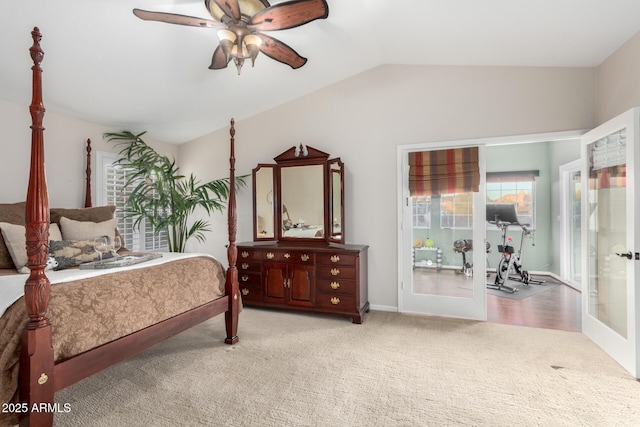 carpeted bedroom featuring a ceiling fan, vaulted ceiling, and french doors