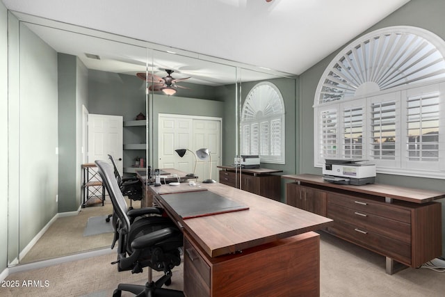 home office featuring light carpet, visible vents, baseboards, and a ceiling fan