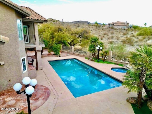 view of pool featuring a patio area, a fenced in pool, an in ground hot tub, and a fenced backyard