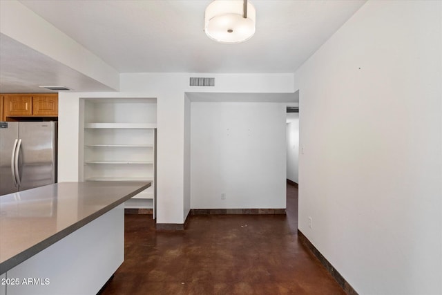 3814 E Poinsettia Dr, Phoenix, AZ 85028 - unfurnished dining area with finished concrete floors, baseboards, and built in features