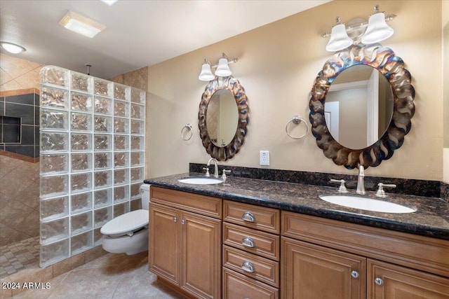 bathroom featuring tile patterned floors, double vanity, a sink, and walk in shower