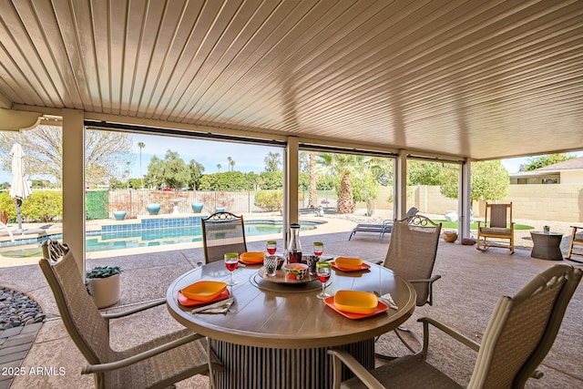 view of patio / terrace with a fenced in pool, outdoor dining space, and a fenced backyard