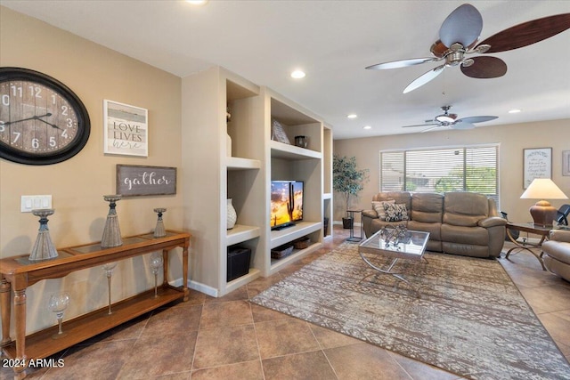 living room featuring built in shelves, recessed lighting, ceiling fan, and baseboards