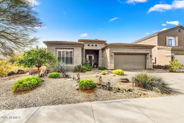 prairie-style home with stucco siding, an attached garage, and driveway