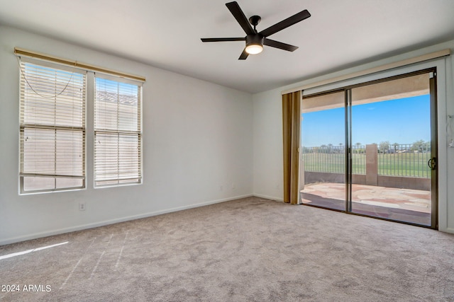 empty room featuring carpet flooring and ceiling fan