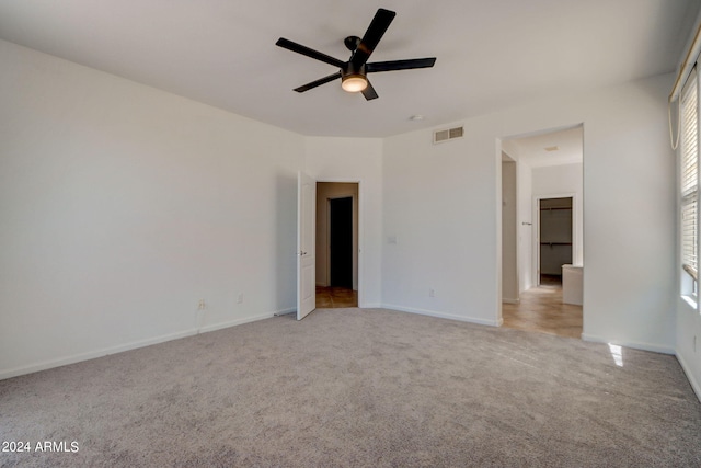 carpeted spare room with ceiling fan