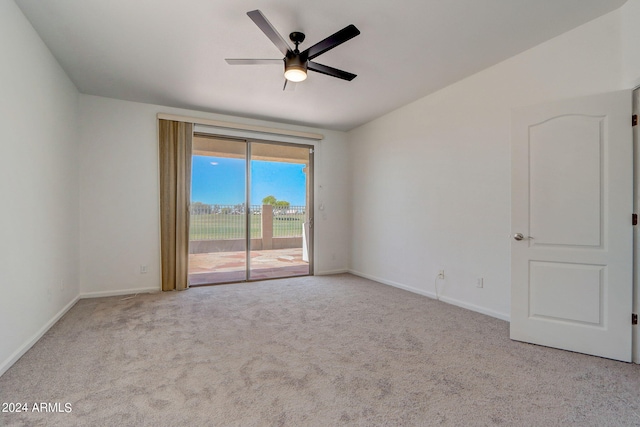 carpeted spare room featuring ceiling fan and lofted ceiling