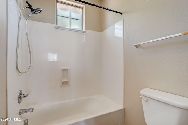 bathroom featuring shower / bathing tub combination and toilet