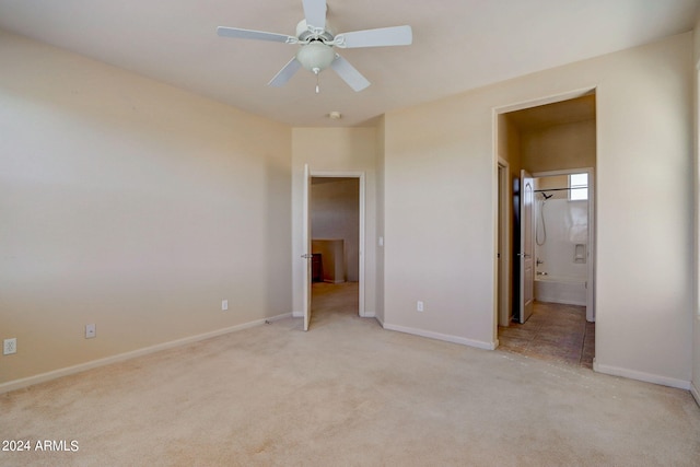 unfurnished bedroom with ensuite bathroom, ceiling fan, and light carpet