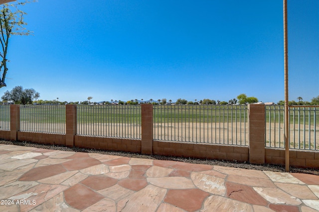 view of gate featuring a patio